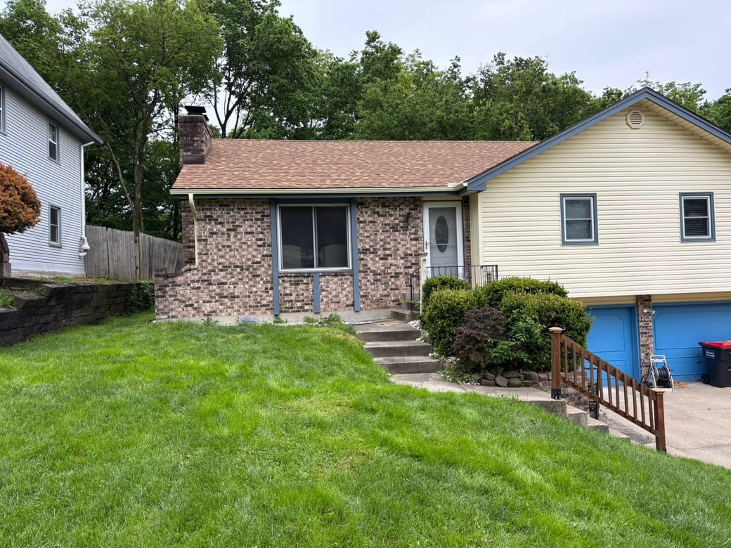 Finished gutter run on a brick-and-siding split-level — work by All Around Gutters